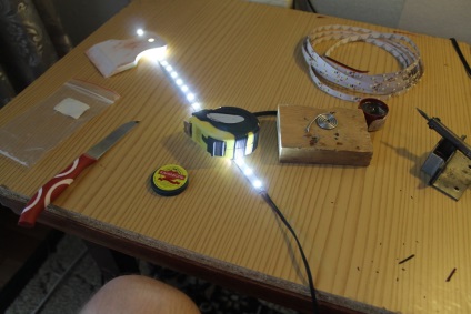 A háttérvilágítás üveg polcok a nappali falán segítségével LED szalag