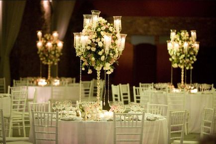 Compoziții pe o masă de nuntă cu candelabru dintr-o poziție a unui ornament și un set de masă de nuntă -