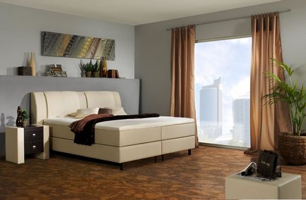 Podeaua din dormitor este umplută cu plută din lemn în interior, designul unui strat de lumină și întuneric alb