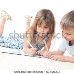 Copii americani care fac temele în timp ce se află pe podea
