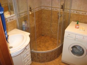 Kis fürdőszoba zuhanyzóval és mosógéppel