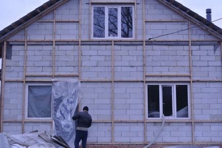 Casa caldă de beton celular la exterior, cu mâinile lor